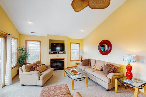 a living room with two couches and a fireplace at Slow M'Ocean #7-HH in Hatteras