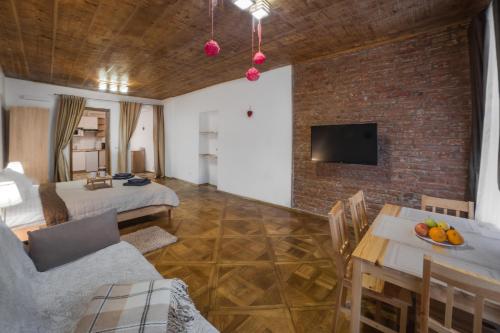 a room with a bed and a brick wall at Luxury apartment with Rynok square view in Lviv