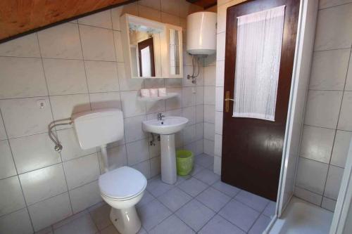 a bathroom with a toilet and a sink at Apartment in Dramalj 5752 in Dramalj