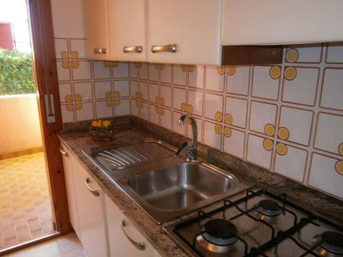 a kitchen with a sink and a stove at Apartments in Bibione 24604 in Bibione