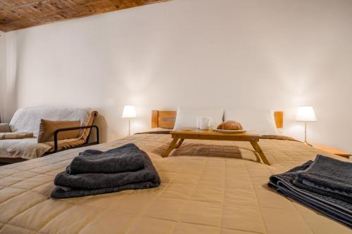 a bedroom with a bed with towels on it at Luxury apartment with Rynok square view in Lviv