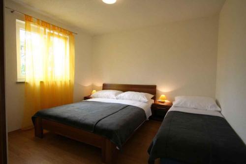 a bedroom with two beds and a window at Apartment in Silo with One-Bedroom 10 in Šilo