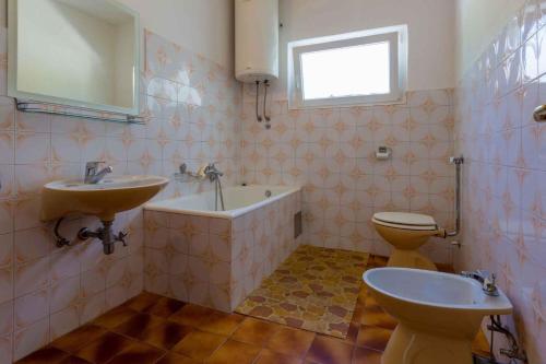 a bathroom with a tub and a sink and a toilet at Apartment in Crikvenica 5555 in Dramalj