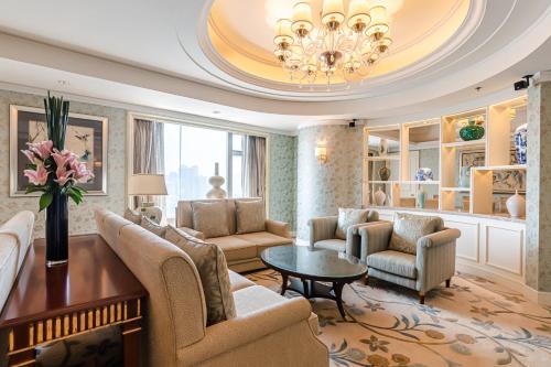 a living room with a couch and chairs and a table at Shangri-La Wuhan,Close to The Mixc with three subway lines in Wuhan