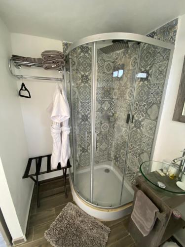 a shower with a glass door in a bathroom at La Finca de Vane in Valle de Guadalupe