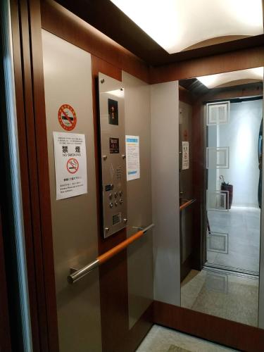 a elevator in a building with a sign on the door at Tung Shiang Homestay in Sanyi