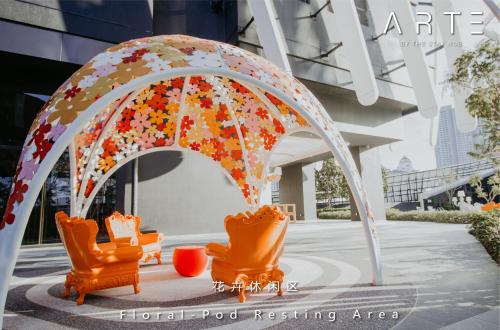 a group of orange chairs and an umbrella at Arte Mont Kiara Luxury Suite with Heated Jacuzzi Pods - Free Parking - Next to MITEC- by The Stay Hub in Kuala Lumpur