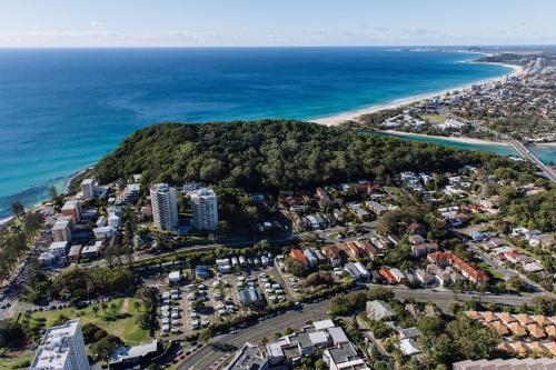 an aerial view of a city and the ocean at Burleigh Beach Tourist Park in Gold Coast