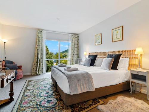 a bedroom with a large bed and a large window at Central Location - 2 Bedroom Apartment in Habeke in Queenstown