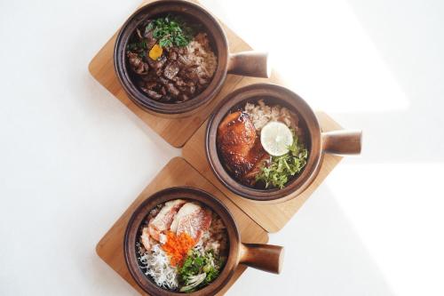 three bowls of food on a wooden plate at WPÜ HOTEL HAKONE in Hakone