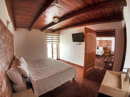 a bedroom with a bed and a tv in a room at Real Carretero in Tapalpa