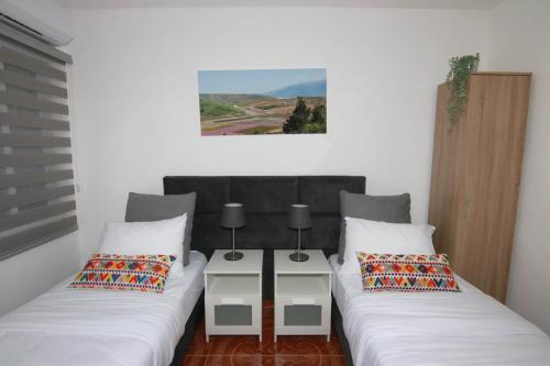 two beds sitting next to each other in a room at עדן במדבר - eden in desert in Yeroẖam