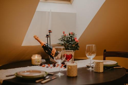 a table with a bottle of wine and glasses at Torma Puhkemaja ja Glämping in Torma
