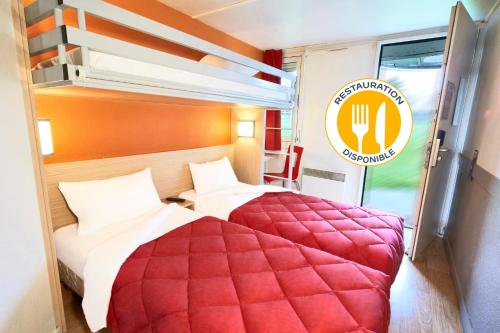 a bedroom with a large red bed in a train at Premiere Classe Toulouse Sud - Portet in Portet-sur-Garonne
