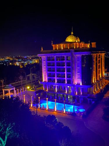a building with blue lights on it at night at LAUR HOTELS Experience & Elegance in Didim