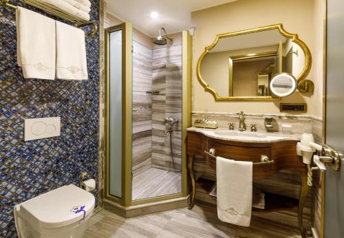 a bathroom with a shower and a sink and a toilet at Romance Istanbul Hotel Boutique Class in Istanbul