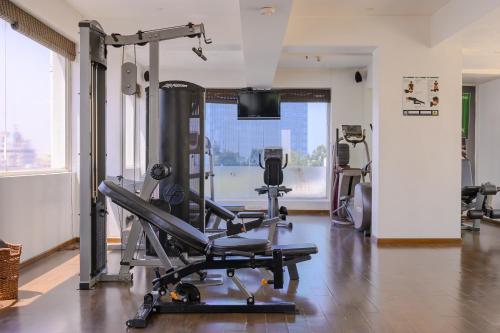 a gym with a tread machine in a room at Melange Astris in Bengaluru