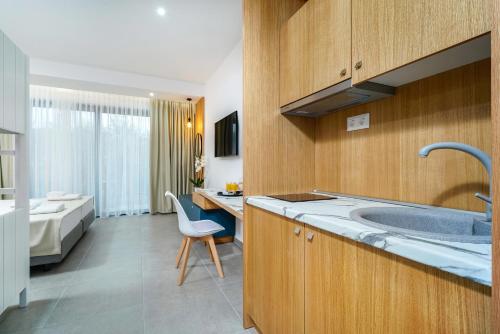 a kitchen with a sink and a bed in a room at Daria Essence in Limenas