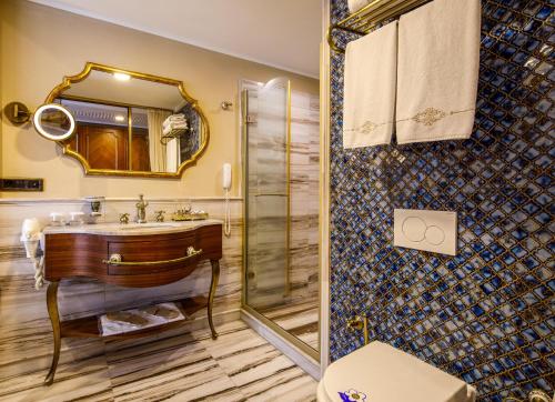 a bathroom with a sink and a shower at Romance Istanbul Hotel Boutique Class in Istanbul