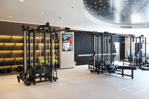 a gym with rows of exercise equipment in a room at Crowne Plaza Shenzhen Futian, Near to Shenzhen Convention&Exhibition Centre, Shenzhen Stock Exchange and Shenzhen Civic Center, Outdoor Heated Pool in Shenzhen