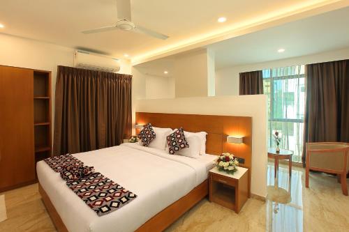a bedroom with a large bed in a room at HOTEL AMALA in Pathanāmthitta