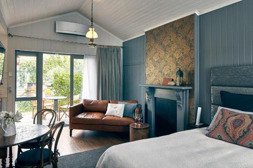 a bedroom with a bed and a table and a couch at Dunstan Times in Clyde