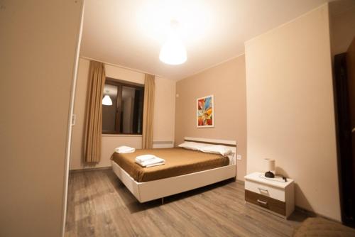 a small bedroom with a bed and a mirror at Апартамент ИЦИ in Pleven