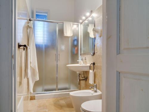 a bathroom with a shower and a toilet and a sink at Farmhouse in Noto with Pool and Garden in Noto