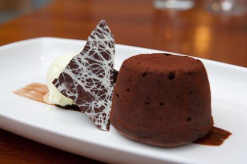 a piece of chocolate cake and ice cream on a plate at The Three Crowns in Chagford