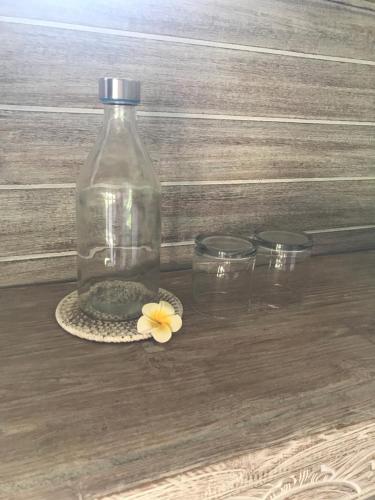a bottle of water and a flower on a coaster at Villa Bali Santai in Kerobokan