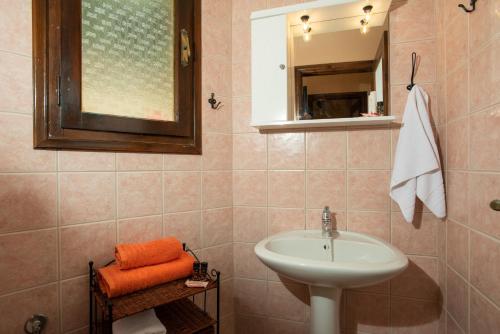 a bathroom with a sink and a mirror at Villa Georgia in Kalyves