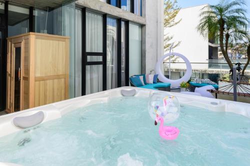 a swimming pool with a pink flamingo in the water at Villa Le Ballon Bleu in Wujie