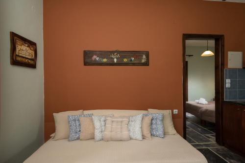 a bedroom with a bed with pillows on it at Villa Georgia in Kalyves