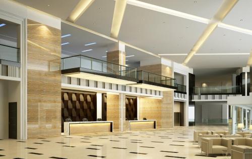 a lobby with chairs and a staircase in a building at Raia Hotel & Convention Centre Kuching in Kuching