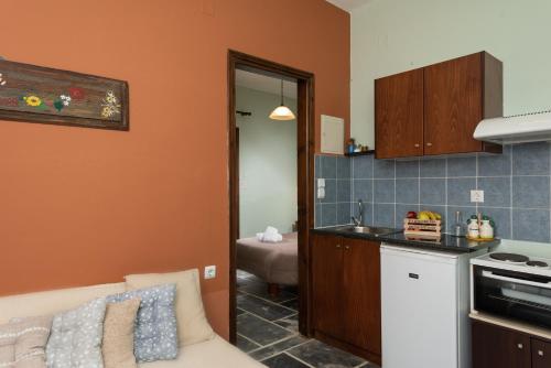 a living room with a couch and a kitchen at Villa Georgia in Kalyves