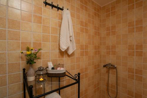 a bathroom with a shower and a vase of flowers at Villa Georgia in Kalyves
