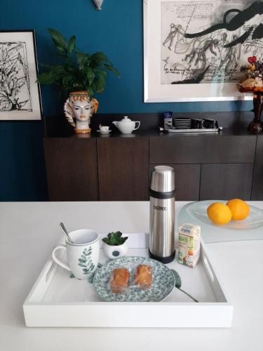 a tray with a coffee maker and a plate of food at La Closerie aux Violettes - Maison d'hôtes in Toulouse