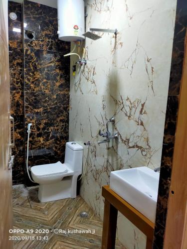 a bathroom with a toilet and a sink at Hotel Byke Ride - Walkable from Agra Cantt Railway Station in Agra