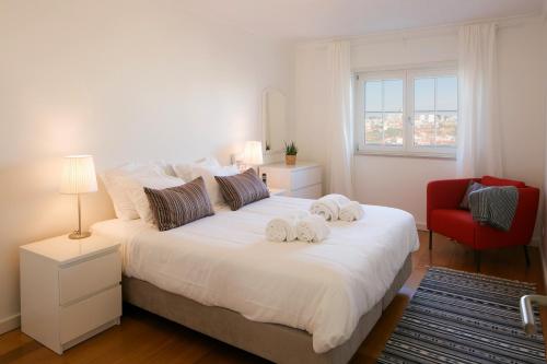リスボンにあるStylish and Beautiful Apartment with Parking 24 by Lisbonne Collectionのベッドルーム1室(大きな白いベッド1台、タオル付)
