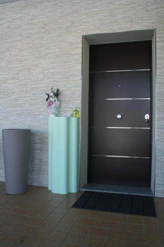 a room with a door and a table with flowers at La Villetta Sul Mavone in Colledara
