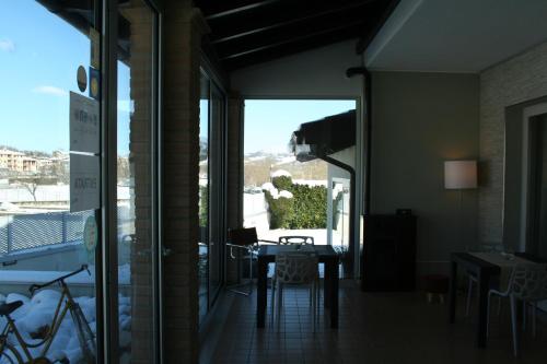 a room with a table and a view of a balcony at La Villetta Sul Mavone in Colledara