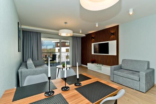 a living room with a couch and a chair at BlueApart Apartamenty Na Klifie in Władysławowo
