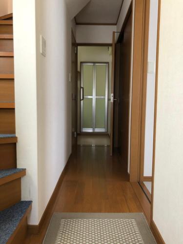 an empty hallway with a door in a building at Izu Shirada Villa 伊豆白田家 in Higashiizu