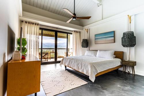 a bedroom with a bed and a balcony at HBR Suite 9304, 5, 6 in Princeville