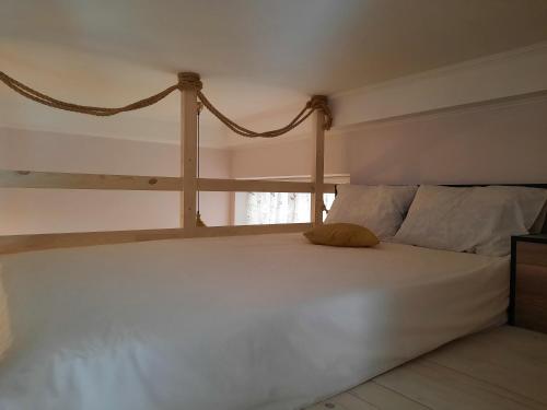 a bedroom with a large white bed and a window at Сьоме Небо in Lviv