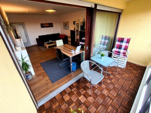 a living room with a couch and a table and chairs at 1,5 Zimmer Apartments mit traumhafter Aussicht in Bad Kissingen