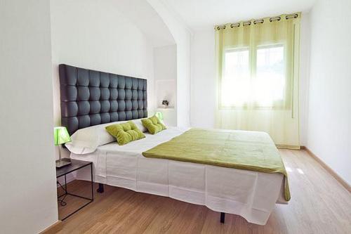 a bedroom with a large bed and a window at Lavander in Sitges