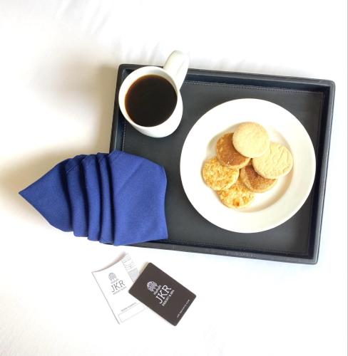 a plate of cookies and a cup of coffee at The Residency Towers, Rameswaram in Rāmeswaram