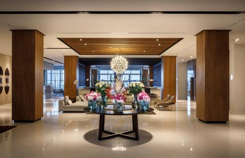 a lobby with a table with flowers on it at Hotel Ambasador - Liburnia in Opatija