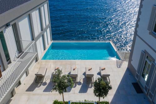 a swimming pool on the balcony of a building with the ocean at Barreirinha Suite Top Floor by Holiday Rental Madeira in Funchal